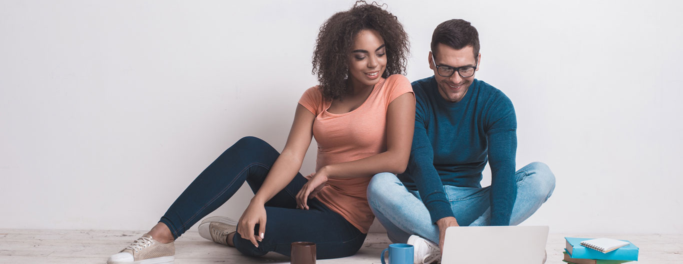 Woman and man looking at laptop